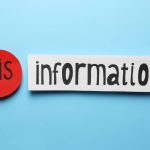A stock image of a blue back ground with the word "information" written on a piece of white paper, and in front of it the prefix, "mis" written on a round red dot.