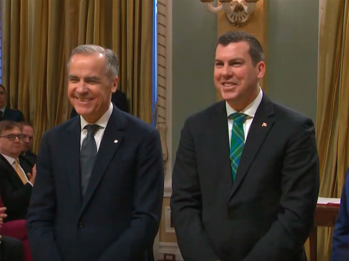 Canada's new Minister of Agriculture, Kody Blois, poses with Prime Minister Mark Carney shortly after being sworn in.