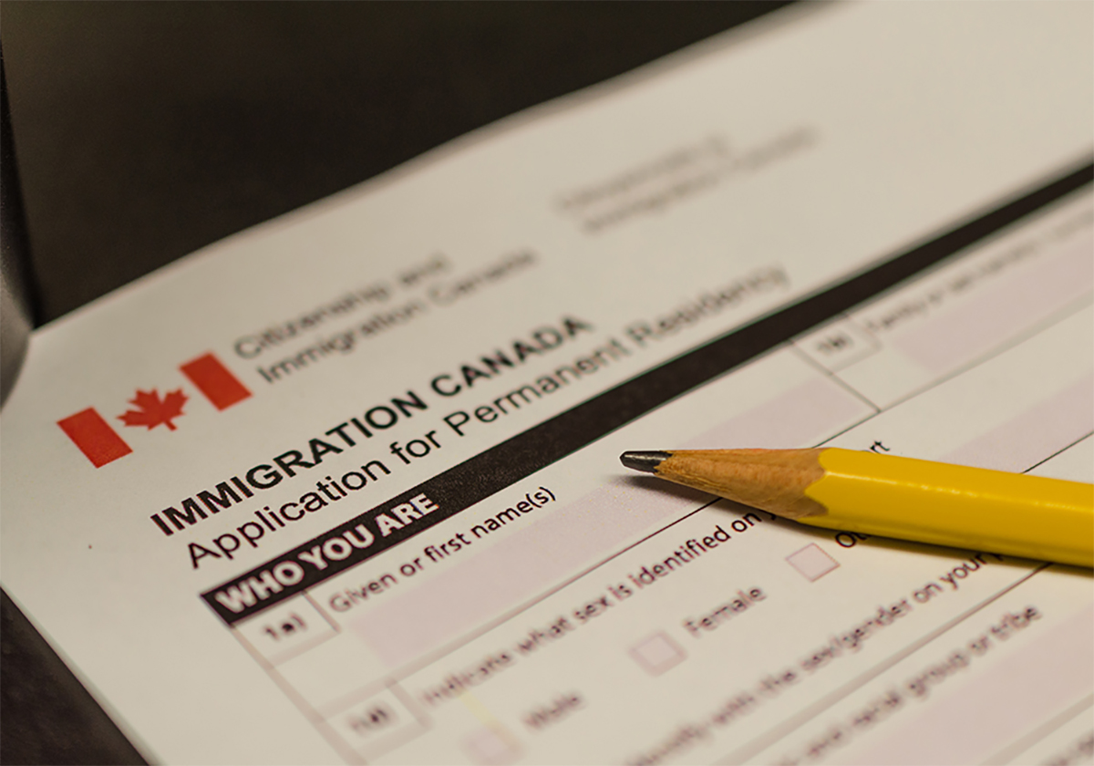 Close-up photo of an official-looking government form that says, "Immigration Canada" in the upper lefthand corner with a pencil laying on it.