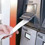 A customer gets a receipt directly from the gas pump after filling up with fuel.