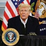 U.S. president Donald Trump speaks from a lectern with the presidential seal on it.