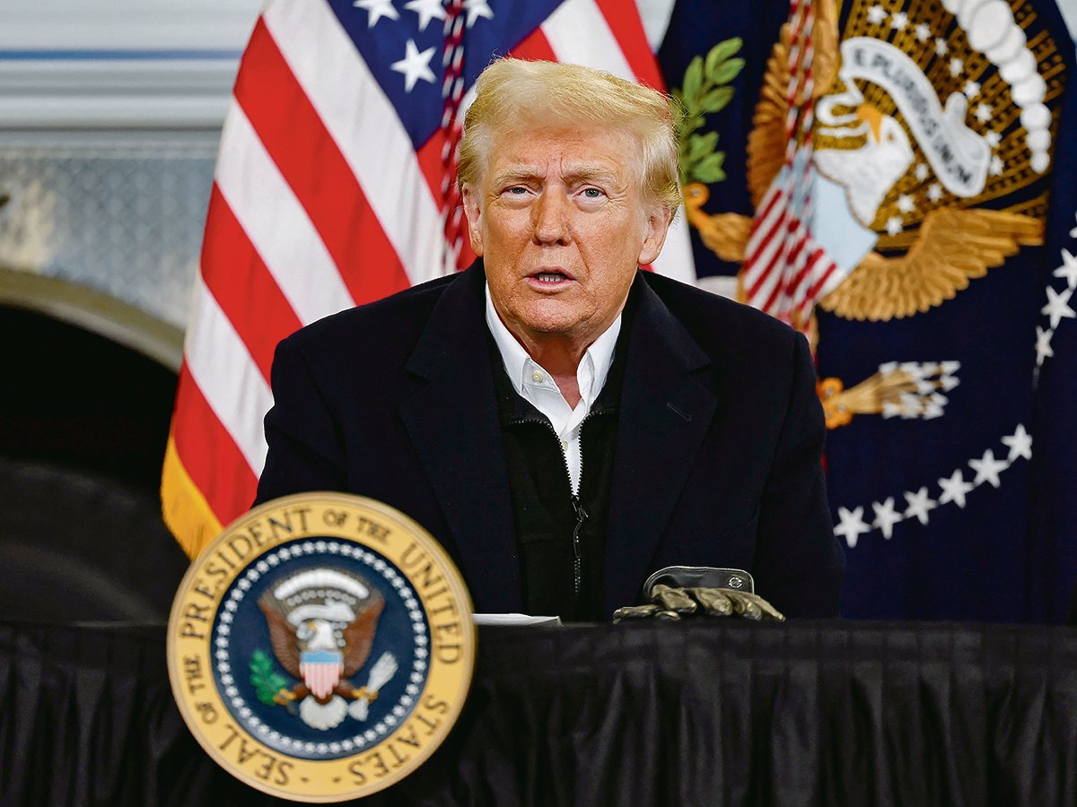 U.S. president Donald Trump speaks from a lectern with the presidential seal on it.