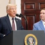 Donald Trump speaks from a podium with the presidential seal on it at the White House.