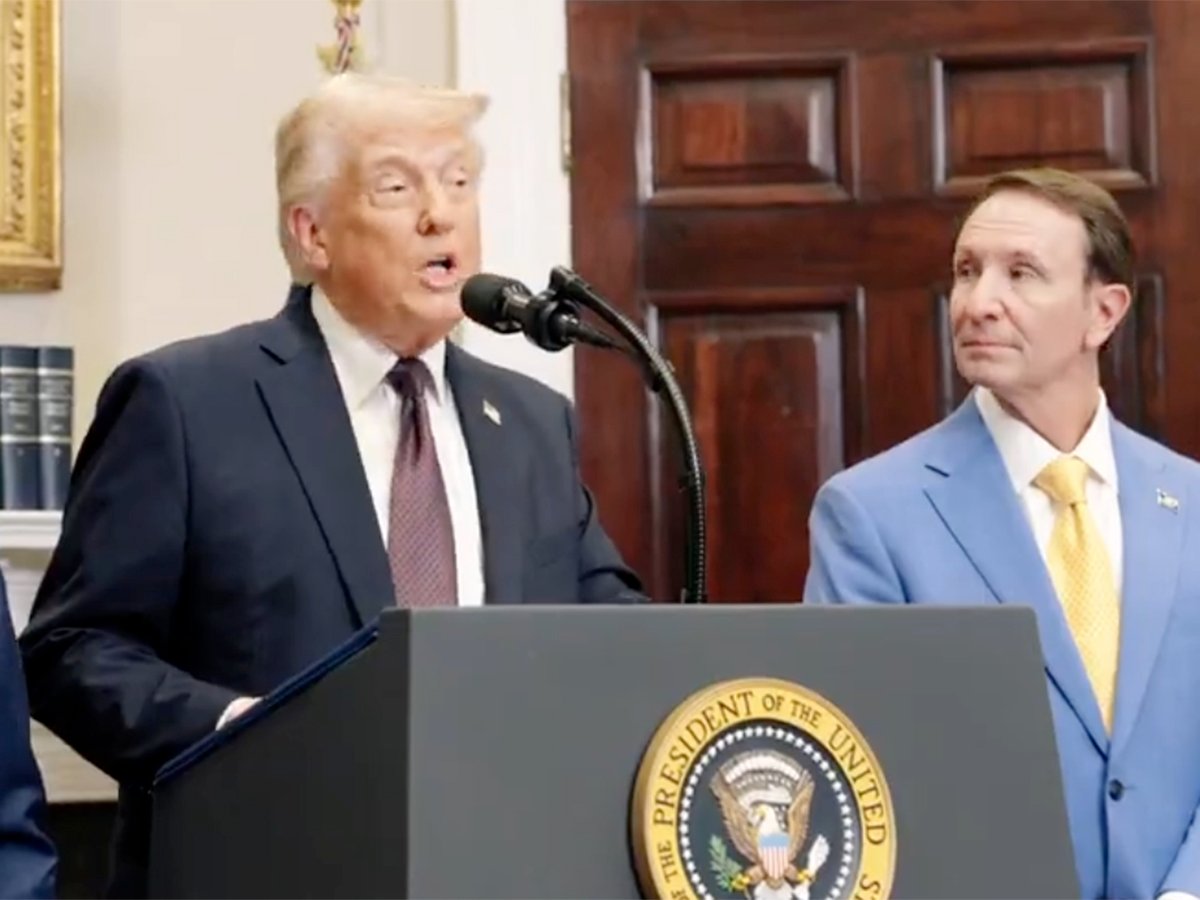 Donald Trump speaks from a podium with the presidential seal on it at the White House.