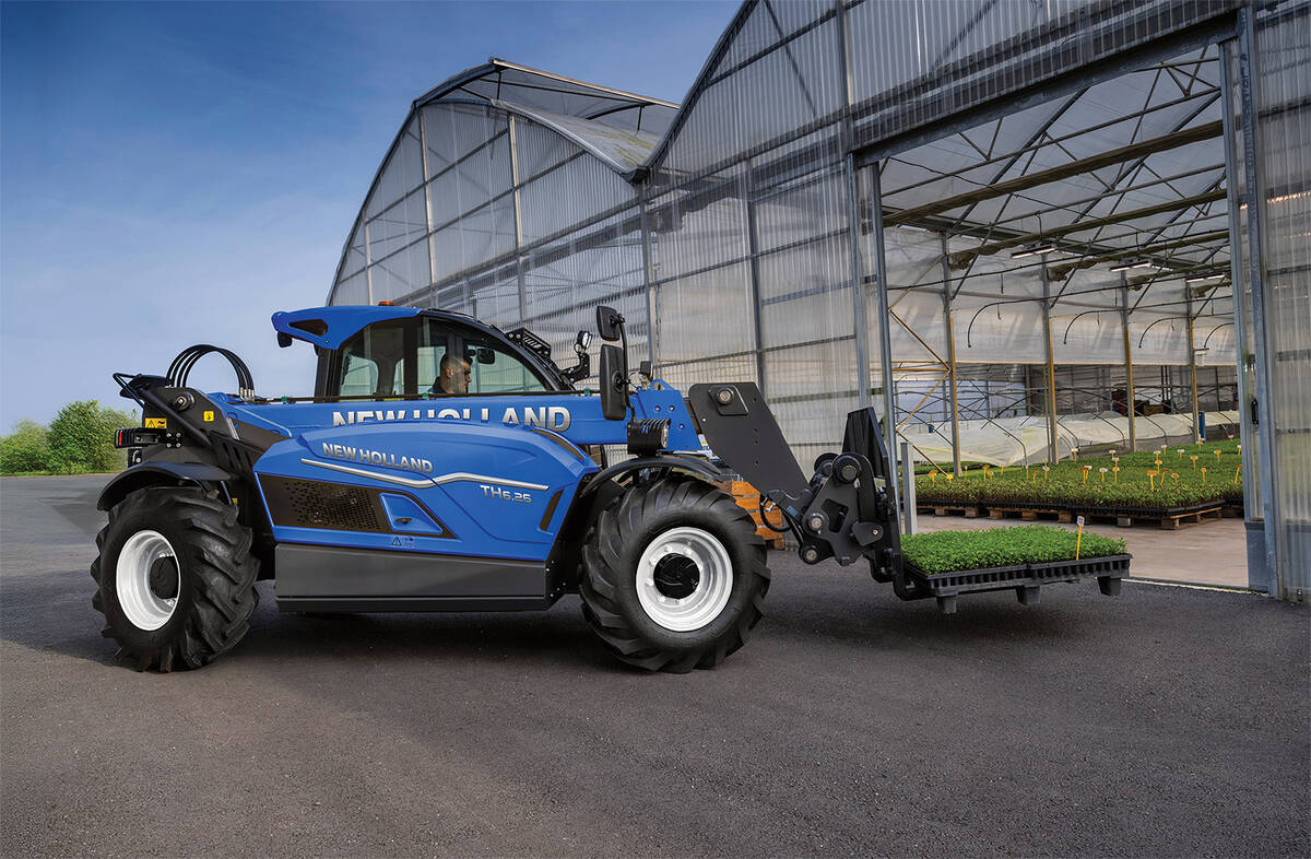 A photo of New Holland's new TH6.26 telehandler carrying a pallet of plants just outside a greenhouse.