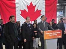 Manitoba premier Wab Kinew, with Manitoba Agriculture Minister Ron Kostyshyn (left) and Minister of Municipal and Northern Relations Glen Simard (far left), announce farm support against tariffs at Maple Leaf Foods in Brandon April 2.