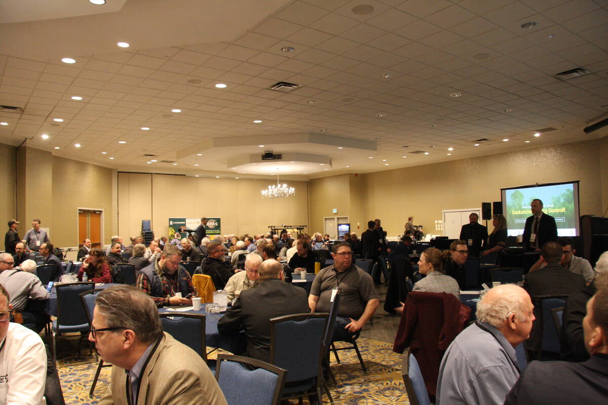 People sit at tables in a large meeting room during the Sask. Ag. Summit 2025.