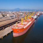 Bulk container ships sit alongside a dock in China.