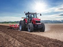 A tractor pulls a disk using satellite guidance.