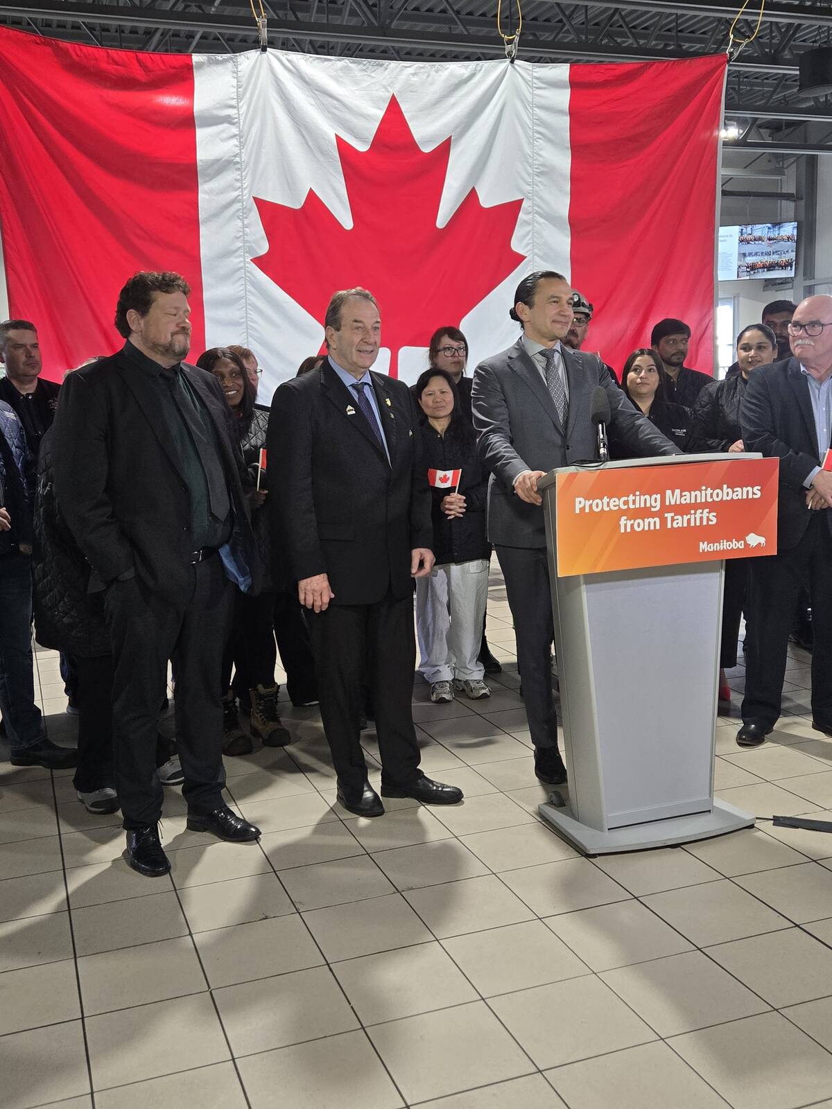 Premier Wab Kinew, with Manitoba Agriculture Minister Ron Kostyshyn (left) and Minister of Municipal and Northern Relations Glen Simard (far left), announce farm support against tariffs at Maple Leaf Foods in Brandon April 2.