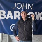 Conservative party agriculture critic John Barlow stands in front of a flag with his name on it.