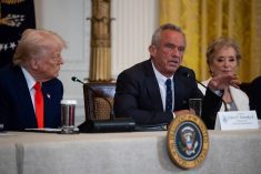 U.S. President Donald Trump is seated at a table next to Secretary of Health and Human Services Robert F. Kennedy Jr.