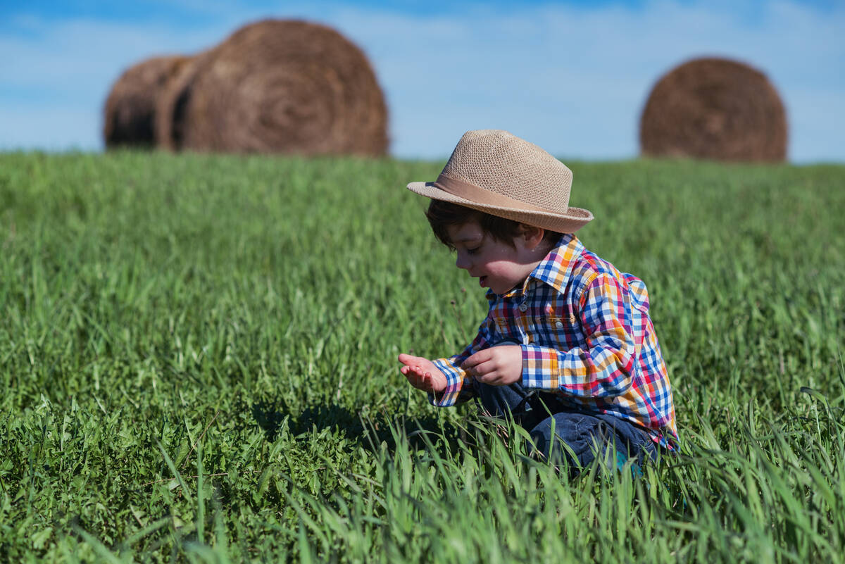 A 4-year-old boy plays in a field.