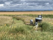 Scientific instruments sit in a field.