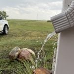 Water spills from a downspout on a home southeast of Delisle, Saskatchewan.