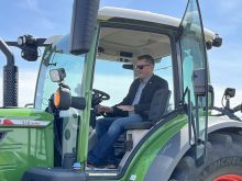 Alberta Minister of Agriculture and Irrigation RJ Sigurdson sits in a tractor at a funding announcement at Farming Smarter near Lethbridge.