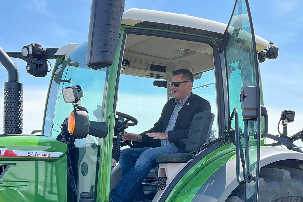 Alberta Minister of Agriculture and Irrigation RJ Sigurdson does the ceremonial fire up of Farming Smarter’s new tractor it was able to purchase with the help of the province’s one-time capital grant of $3.2 million to Alberta’s 12 applied research associations. The boost to Farming Smarter’s equipment for potato research helps with the association’s operating costs as a non-profit association. Photo: Greg Price
