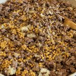 A big batch of ground beef, with cooked lentils mixed in, in a skillet.