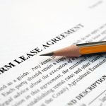 Close-up of a pencil laying on an official document entitled, "Farm Lease Agreement."