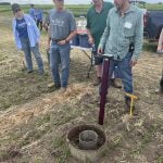 Photo by Greg Price
Dr. Henry Chau shows off a FieldScout TDR 350 to onlookers which measures volumetric water content, electrical conductivity and turf surface temperature. Chau's presentation, 'Tools for Measuring Soil Physical Health,' was part of Farming Smarter's field school in late June.