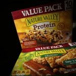 Two boxes of Nature Valley bars, one containing protein and one without, are seen in this photo illustration in Wilmette, Illinois, September 12, 2014. Protein has so far scored a big win for companies which are looking for new ways to beef up their profits as sales of traditional prepared foods slip and consumers seek healthier and fresher food options. General Mills, which Wednesday reported lower-than-expected quarterly profit, is counting on its protein-fortified snacks and expanded Yoplait Greek yogurt line to boost profits. Its Nature Valley protein bars, introduced in 2012, made over $100 million in sales in their first year. To match analysis USA-RETAIL/PROTEIN REUTERS/Jim Young (UNITED STATES - Tags: BUSINESS FOOD HEALTH)