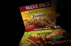 Two boxes of Nature Valley bars, one containing protein and one without, are seen in this photo illustration in Wilmette, Illinois, September 12, 2014. Protein has so far scored a big win for companies which are looking for new ways to beef up their profits as sales of traditional prepared foods slip and consumers seek healthier and fresher food options. General Mills, which Wednesday reported lower-than-expected quarterly profit, is counting on its protein-fortified snacks and expanded Yoplait Greek yogurt line to boost profits. Its Nature Valley protein bars, introduced in 2012, made over $100 million in sales in their first year. To match analysis USA-RETAIL/PROTEIN REUTERS/Jim Young (UNITED STATES - Tags: BUSINESS FOOD HEALTH)