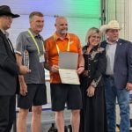 PhiBer Manufacturing won the AgTech innovation award for its drone carrier at the Ag in Motion innovation program, with Saskatchewan Minister of Agriculture Daryl Harrison, right, presenting the award.