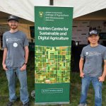 Research Officer Tuan Ha and summer lab student Shawn Neudorf at the University of Saskatchewan's booth at Ag in Motion 2025.