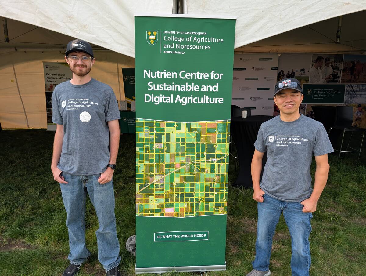Research Officer Tuan Ha and summer lab student Shawn Neudorf at the University of Saskatchewan's booth at Ag in Motion 2025.