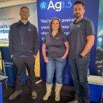 (Left to Right) Kyle Gibson, Sharene Cunningham and Paul Munro stand at Agi3's booth at Agriculture in Motion on July 15, 2025.