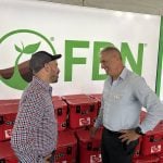 Nigel Buffone, left, Farmers Business Network’s senior director of crop protection, talks to Breen Neeser, FBN’s general manager, at the Ag in Motion show in Langham, Sask. Photo: Sean