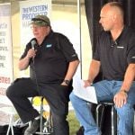 Bruce Burnett, left, and Jerry Klassen talk markets at the Ag in Motion farm show near Langham, Sask.