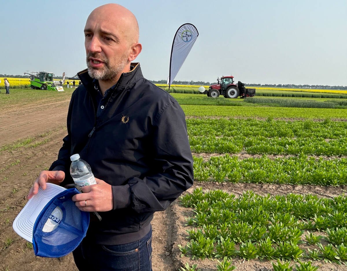 Antoine Bernet, country division head with Bayer Crop Science in Canada, believes that oilseed crops grown in Canada have a huge opportunity to supply growing demand for biofuels. Next to Bernet is a camelina plot at the Bayer research farm near Saskatoon