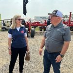 Canadian Chief Trade Commissioner Sara Wilshaw speaks with Scott Scherman of Bourgault industries at Ag In Motion 2025, near Langham, Sask.