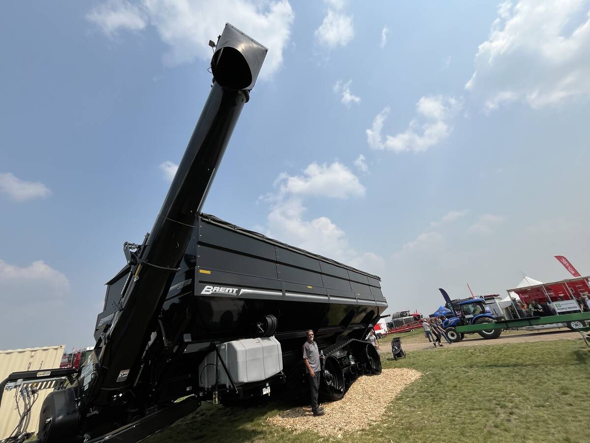 Photo by Greg Price
Shawn Berry, territory manager for Unverferth Manufacturing Company is dwarfed by the sheer size of the new Brent 3298 Avalanche dual-auger grain cart with its 3,150 bushel hopper capacity.