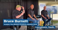 Bruce Burnett, left, Jerry Klassen and Ranulf Glanville talk markets at the Ag in Motion farm show near Langham, Sask.
