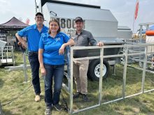 Gerard Roney, right, of Advantage Feeders, pictured here with Marlin and Myrna Huber of Huber Ag Equipment, travelled from Australia to Ag in Motion 2025 to discuss creep feeding options for calves and lambs. Photo: Piper Whelan