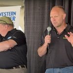 Jerry Klassen, right, and Bruce Burnett talk markets at the Ag in Motion farm show near Langham, Sask.