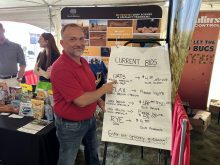 Scott Shiels, grain procurement manager for Grain Millers, shows the company’s current new crop bid at the Ag in Motion 2025 show near Langham, Sask.