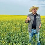 Robert Andjelic, who owns 248,000 acres of cropland in Canada, stands in a massive field of canola south of Whitewood, Sask. Andjelic doesn't believe that technical analysis is a useful tool for predicting farmland values | Robert Arnason photo