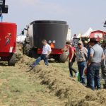 People look at feed at the Total Mixed Ration Demo at Ag in Motion 2025