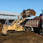 Cattle manure is cleared out of a farm yard in central Manitoba. Photo: Jeannette Greaves