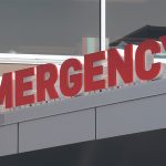 Close-up of the "EMERGENCY" sign at a hospital.