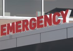 Close-up of the "EMERGENCY" sign at a hospital.