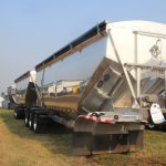 A polished, aluminum grain trailer on display at the Ag in Motion Farm show near Langham, Saskatchewan, in July of 2025.