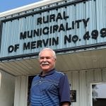 Former federal agriculture minister Gerry Ritz is photographed standing in front of a building with "Rural Municipality of Mervin No. 499" written on it. Ritz has been Reeve of this RM since 2020.