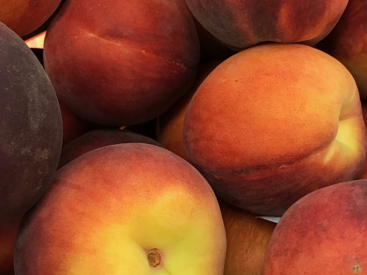 Close-up of a bunch of ripe peaches.