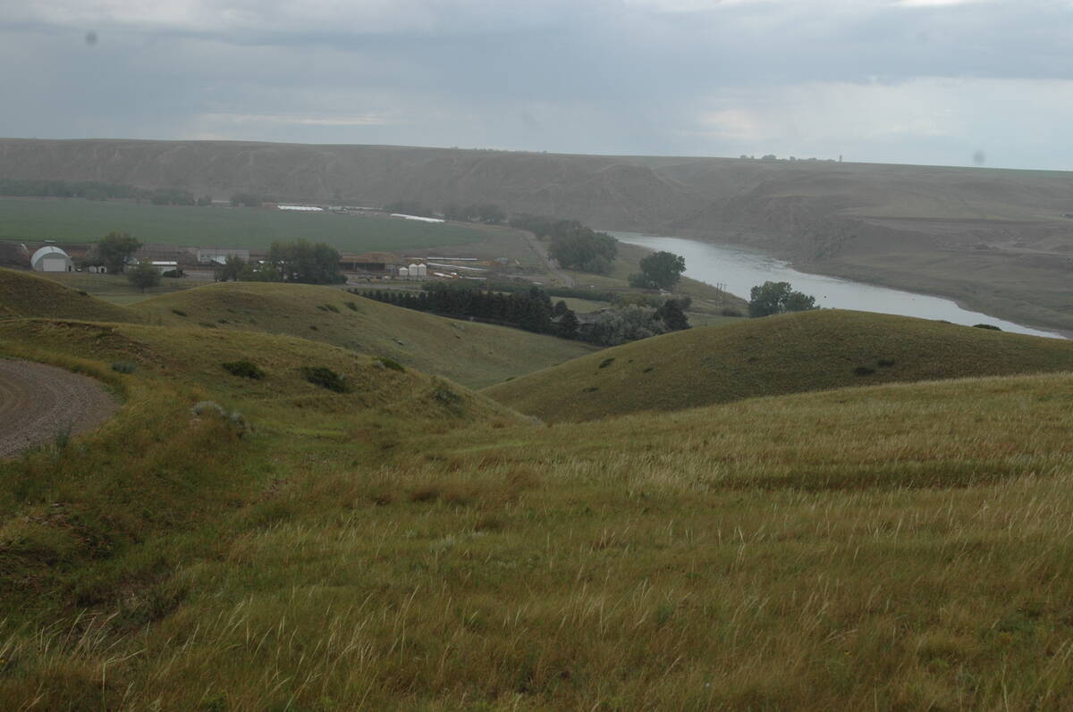 A farm along the Oldman River north of Tempest, Alta., is seen from the hills above on a cloudy day.