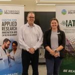 Dr. Andrew Dunlop, associate vice-president – research, left, and Alexis Buzzee, IATC business manager, CARIE, stand together in front of promotional banners during a funding announcement at Lethbridge Polytech on August 13, 2025.