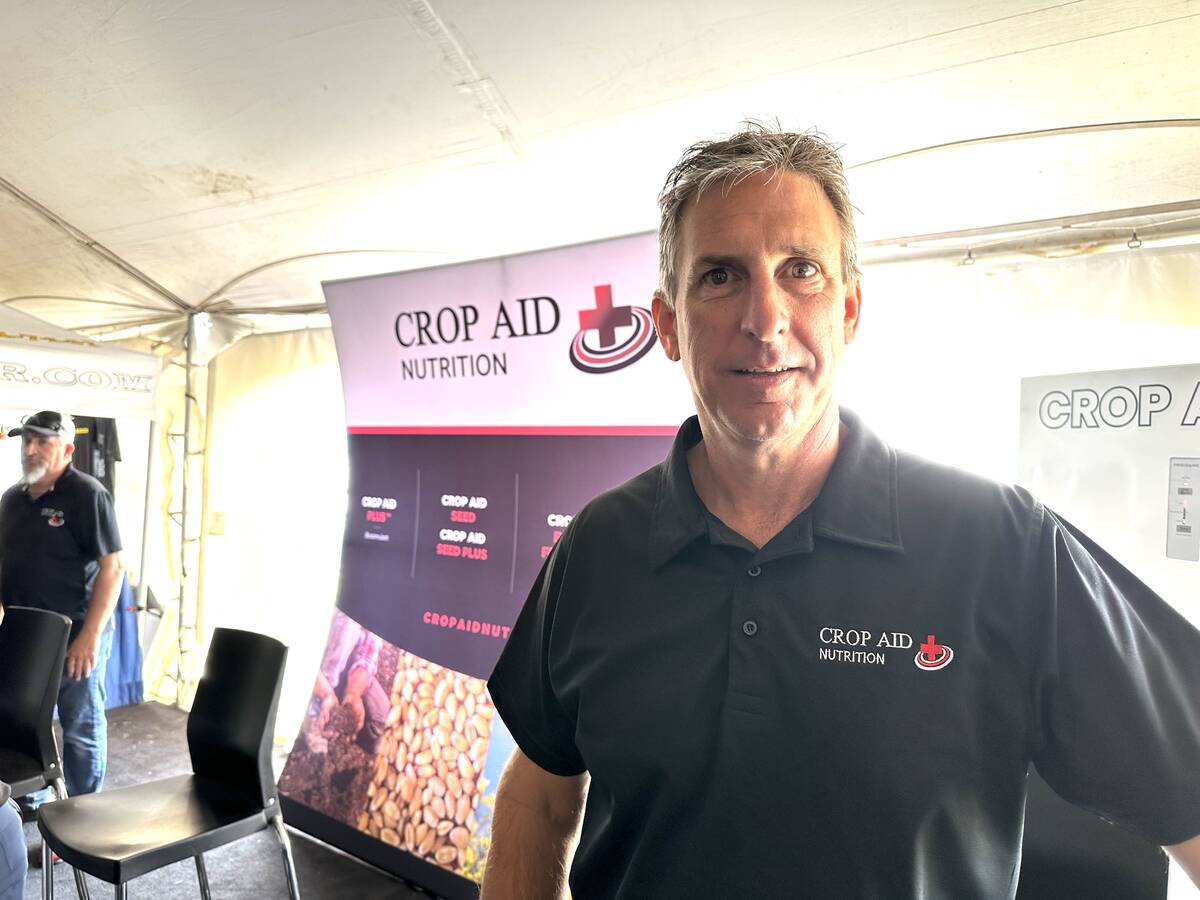 Darren Sander, owner and operator of Crop Aid Nutrition Ltd. at his company's booth at Ag in Motion.